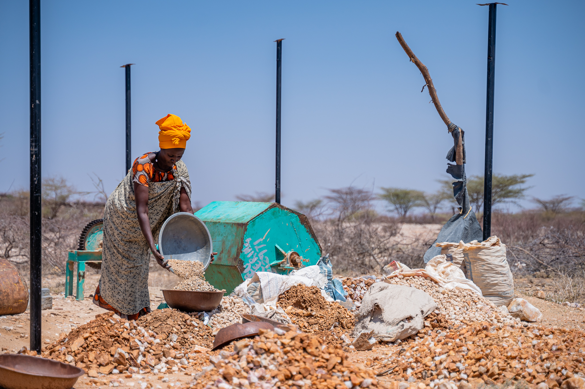Photo credit: Joseph Odongo, Oxfam. Caption: Alice Lourien carries crashes rocks in Turkana County, Kenya 